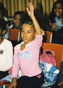 Amber School student raising her hand